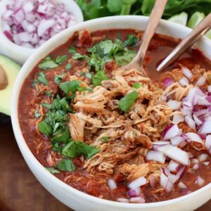 chicken birria in bowl with spoons