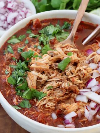 chicken birria in bowl with spoons