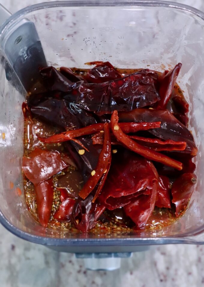 dried chiles in blender with tomatoes and vinegar