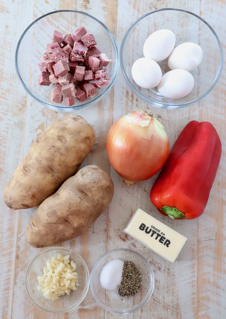 ingredients for corned beef hash on white wood board