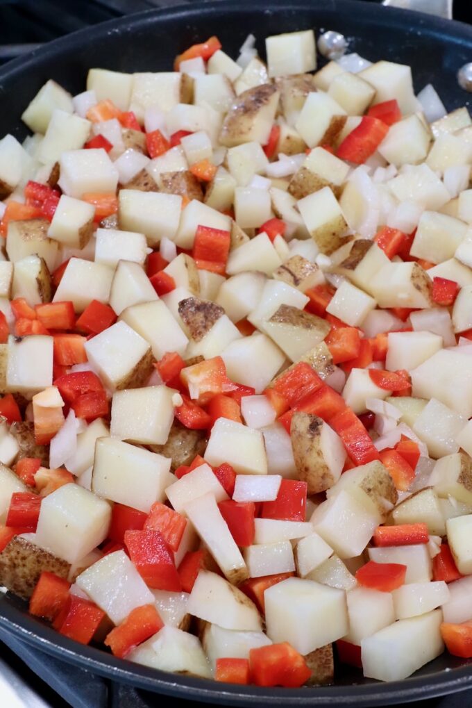 diced onions, potatoes and red bell pepper in a large skillet