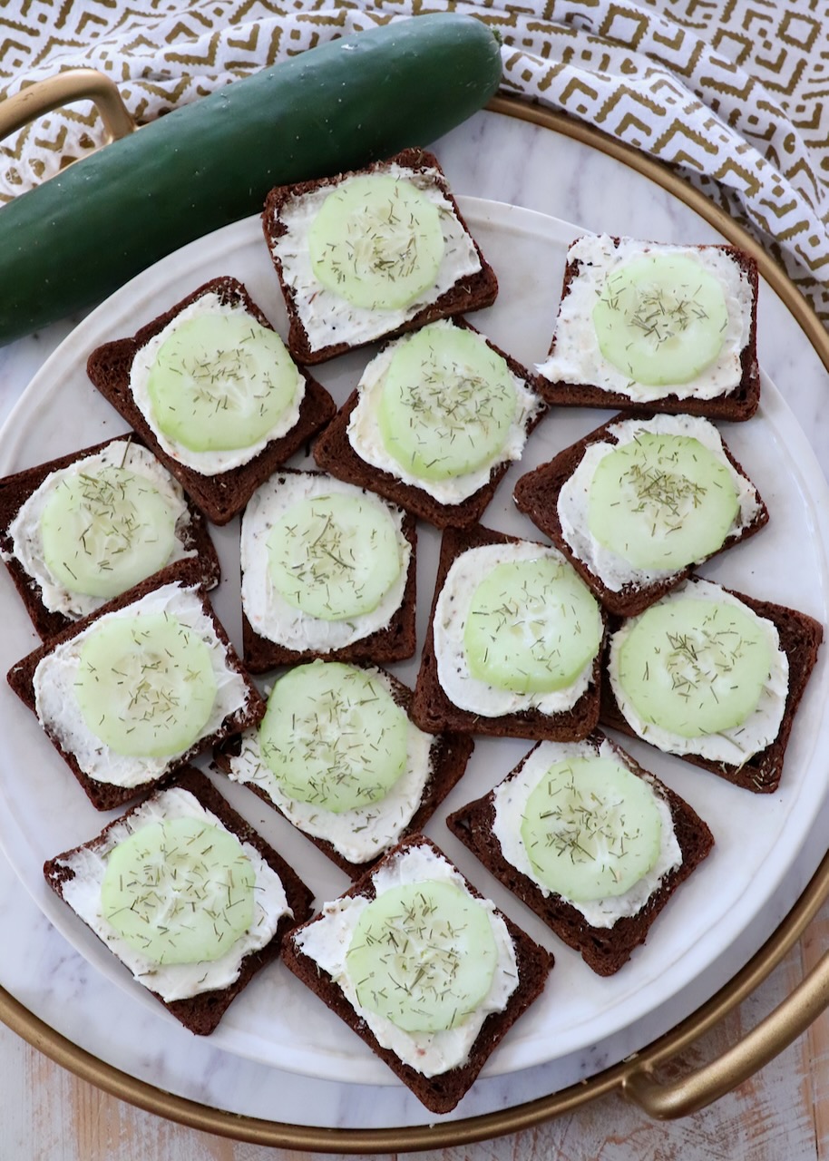 open-face cucumber tea sandwiches on marble serving tray