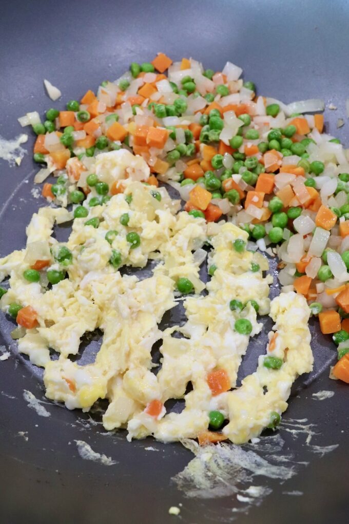 diced veggies and scrambled eggs in large skillet