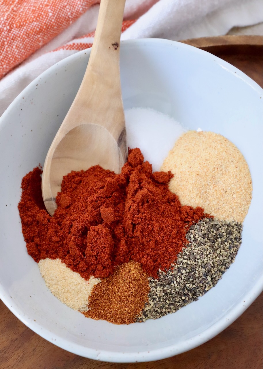 spices separated in bowl with wooden spoon