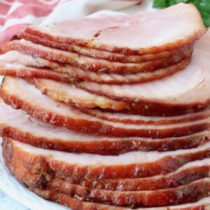 slices of ham stacked up on plate
