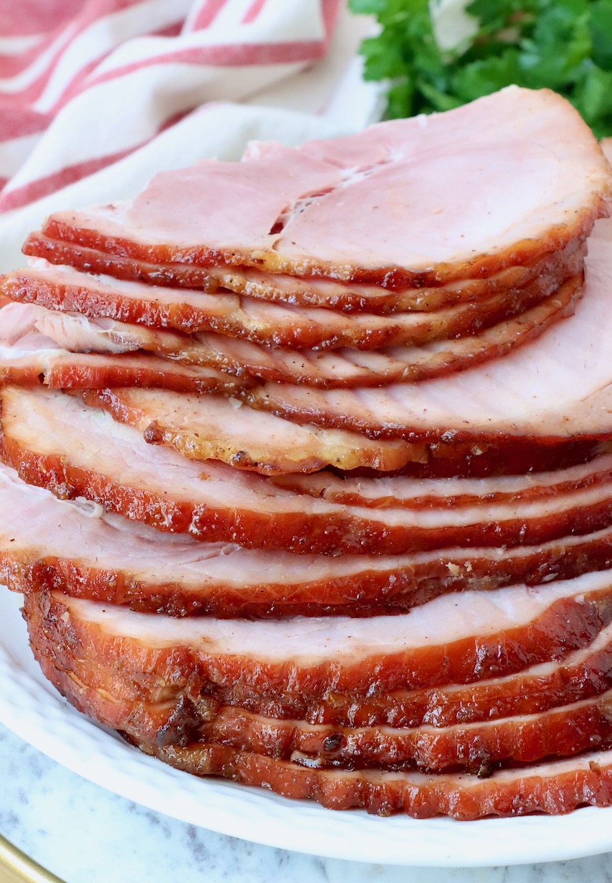 slices of ham stacked up on a plate