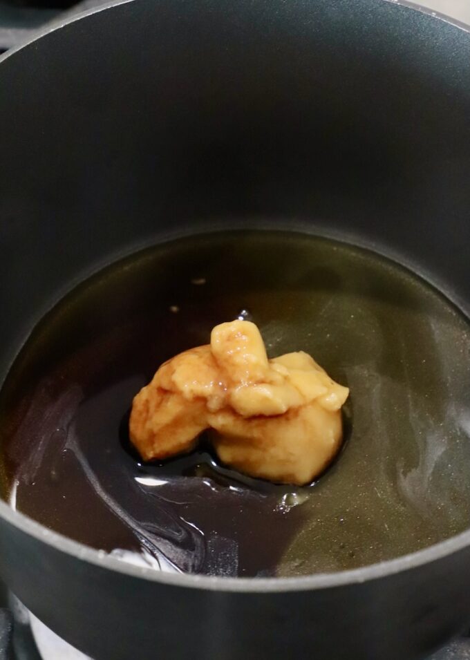 miso paste in a small pot on the stove with sesame oil, honey, mirin and soy sauce