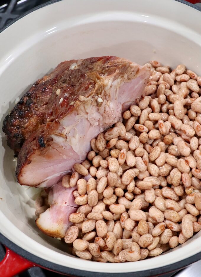 ham leg and dried pinto beans in large pot