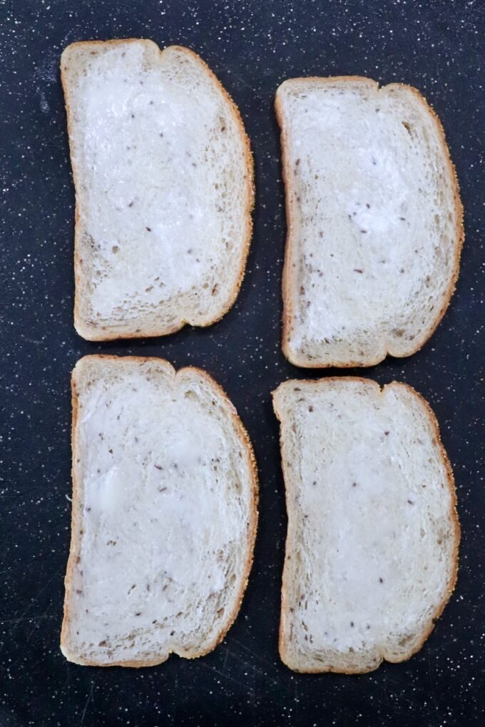 pieces of buttered bread on cutting board