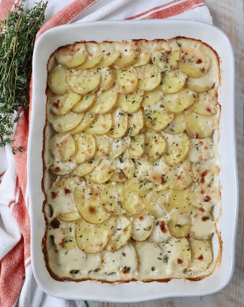 cooked scalloped potatoes in baking dish