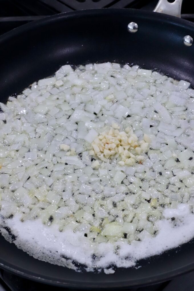 diced onions and minced garlic in skillet with melted butter