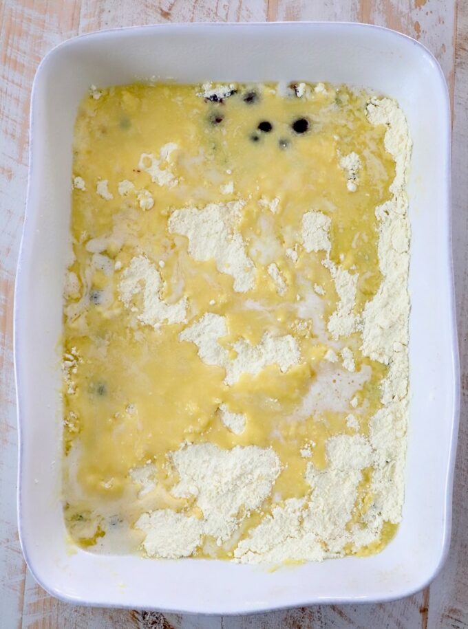cake mix covered in melted butter in baking dish
