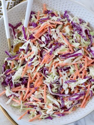 coleslaw in bowl with spoons