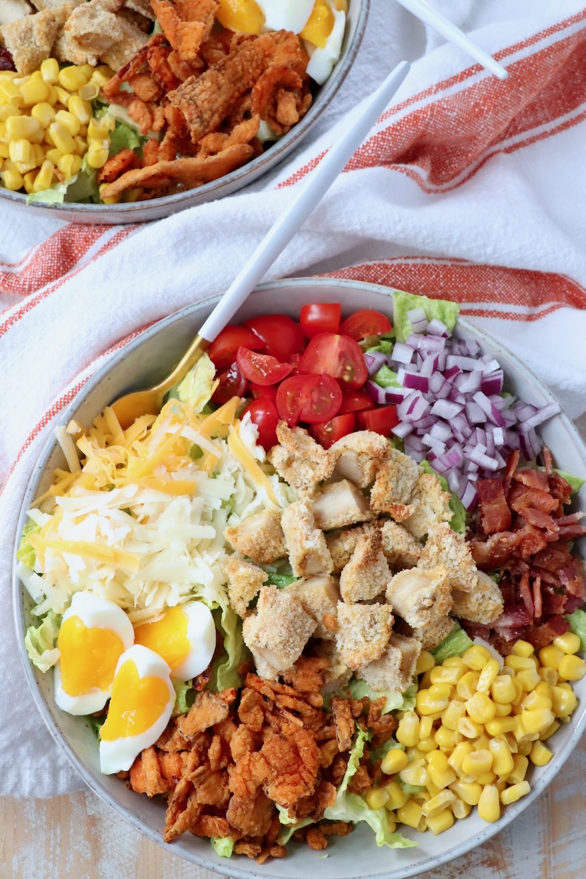 crispy chicken salad in bowl with fork