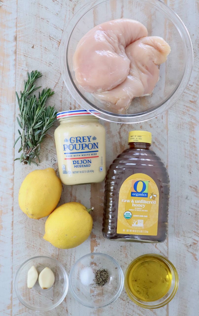 ingredients for honey mustard chicken on white wood board