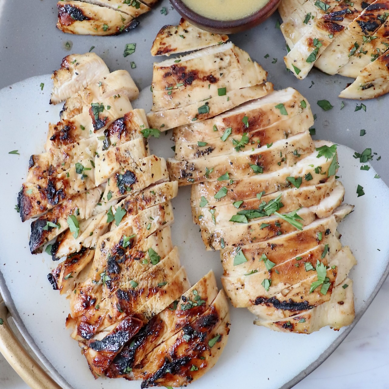 sliced grilled chicken on plate