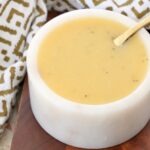 honey mustard dressing in bowl with spoon