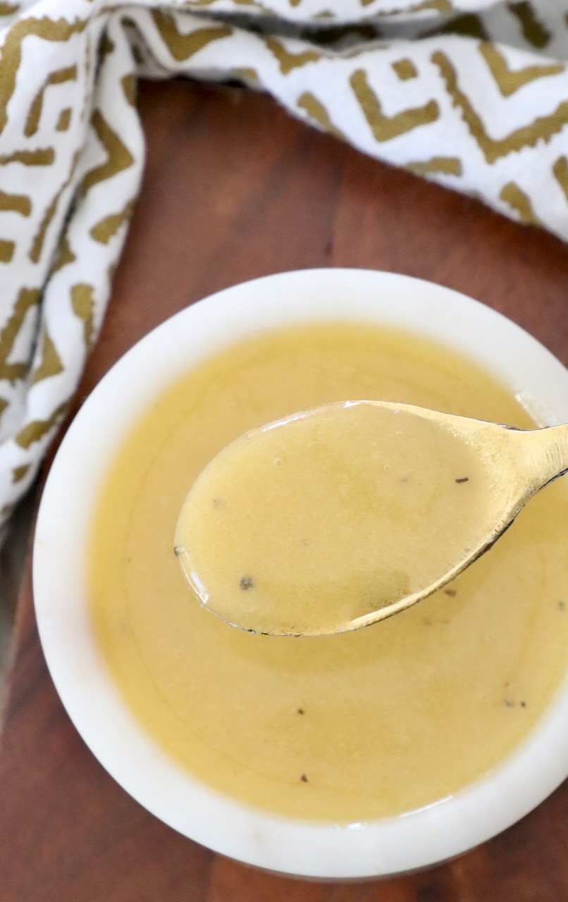 honey mustard dressing in bowl with small spoon