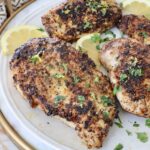 cooked lemon pepper chicken breasts on plate