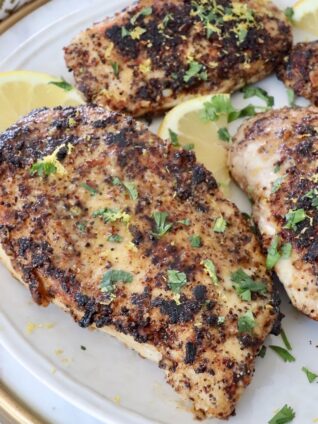cooked lemon pepper chicken breasts on plate