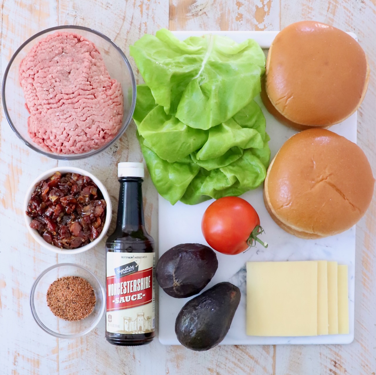 ingredients for California burgers on white wood board