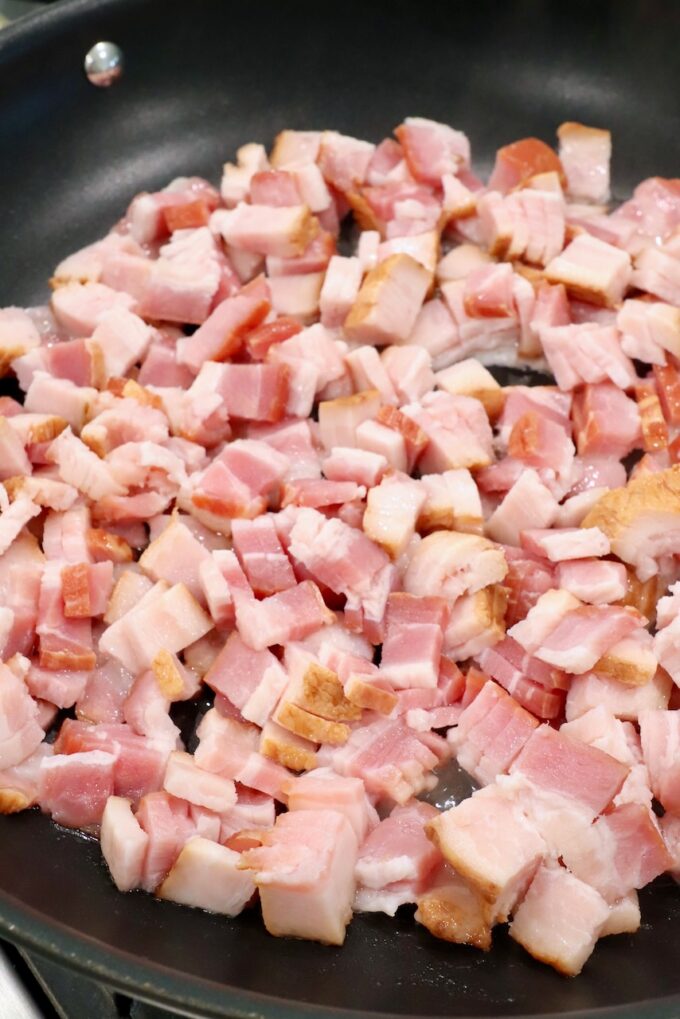 diced uncooked bacon in skillet