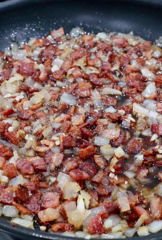 diced cooked bacon and onions in skillet