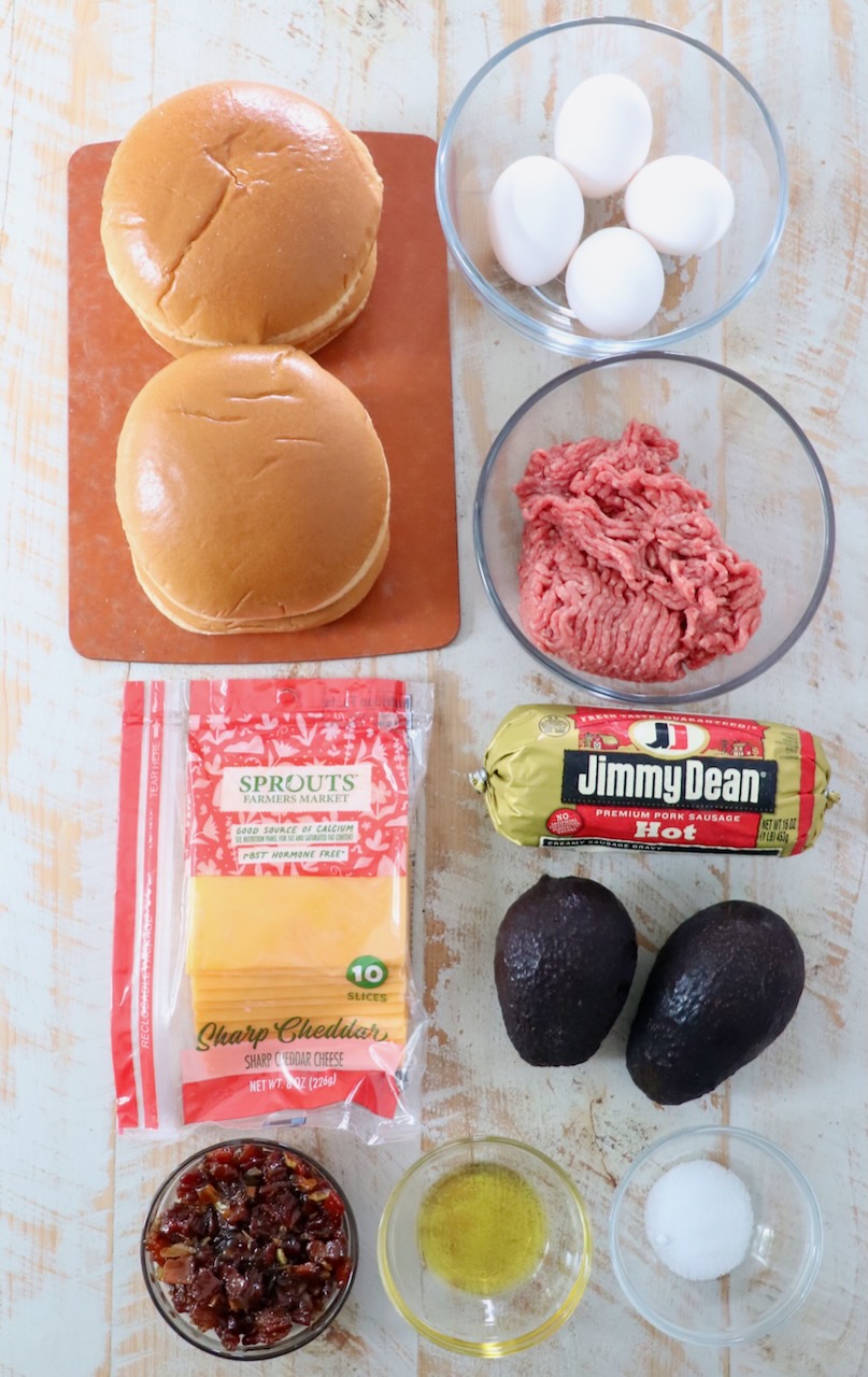 ingredients for breakfast burger on white wood board