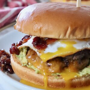 burger on plate topped with fried egg and bacon jam