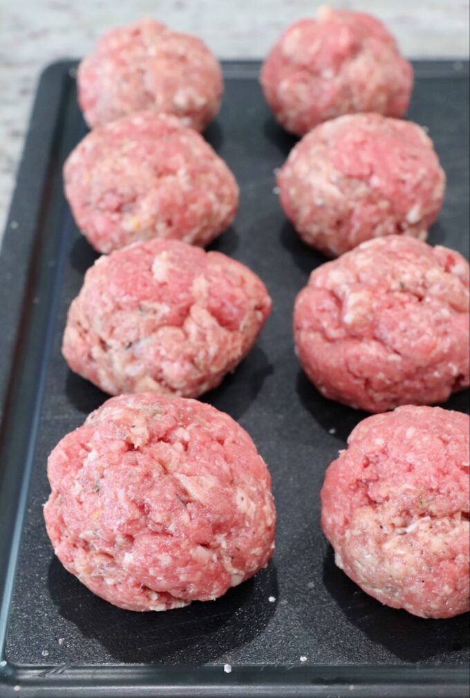 balls of beef and sausage on cutting board