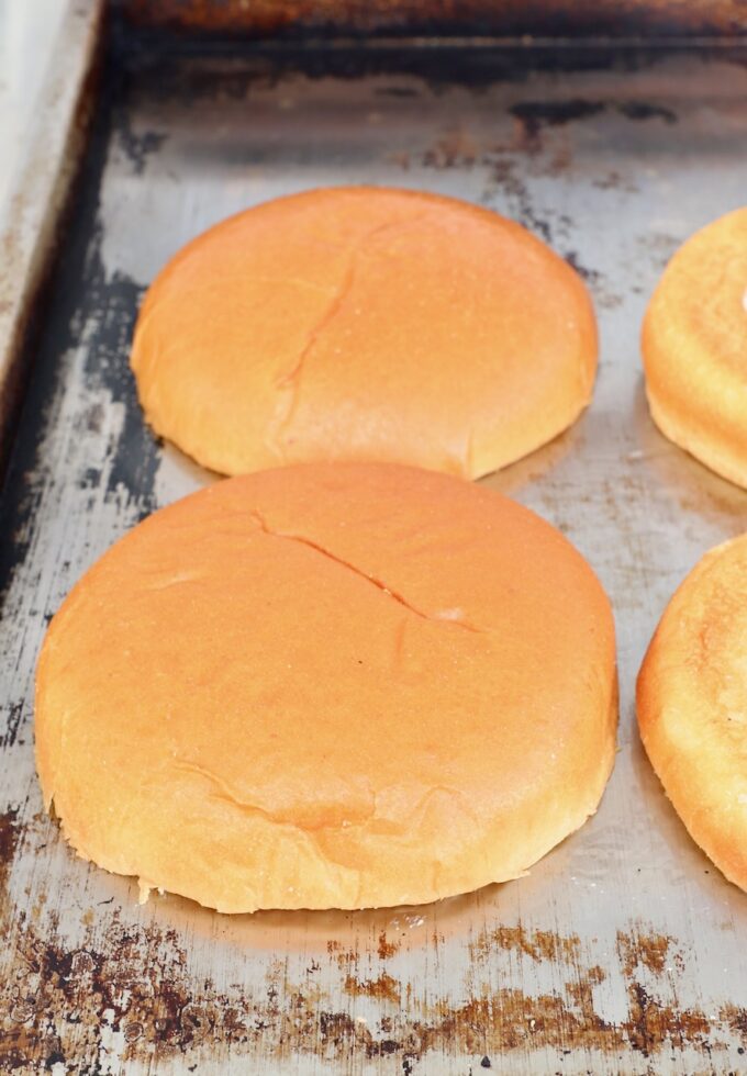 hamburger buns toasting on flat top