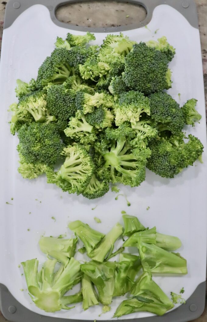 broccoli florets and stems on cutting board