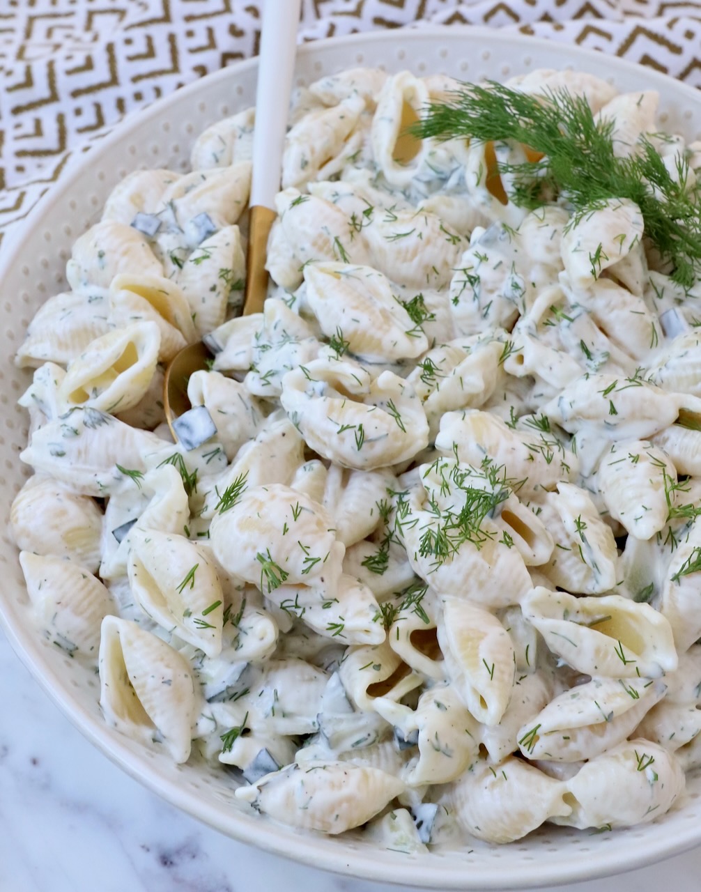 creamy pickle pasta salad in bowl with spoon