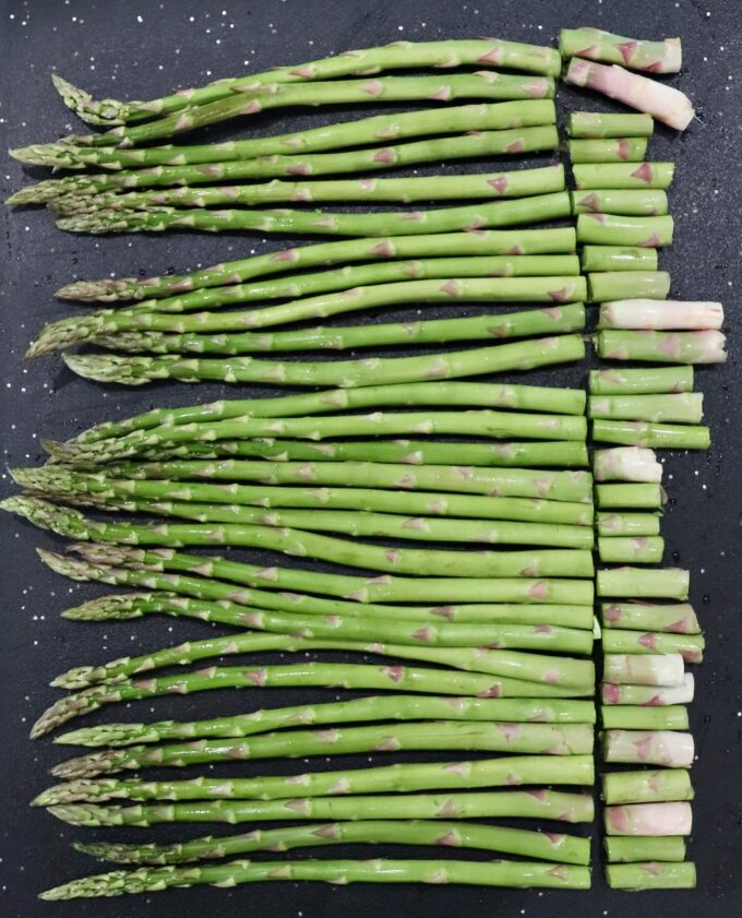 asparagus on cutting board with ends removed