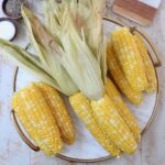 cooked corn on the cob on marble serving tray