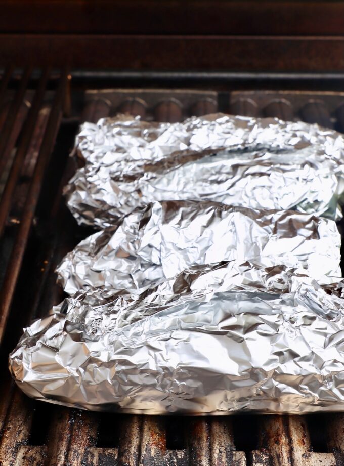 foil wrapped corn on the cob on grill