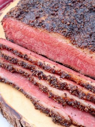 smoked pastrami sliced on wood board