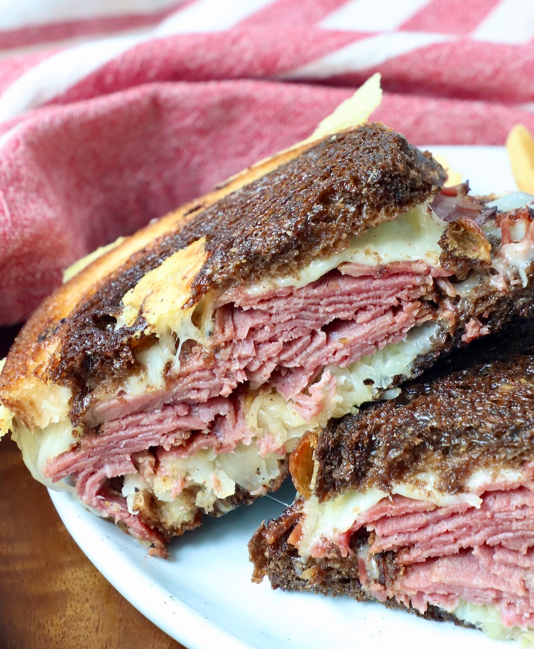 hot pastrami sandwich stacked up on plate