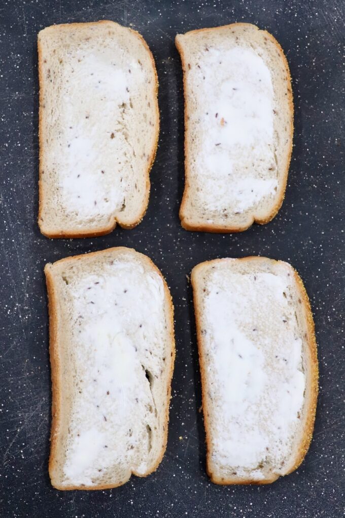 buttered slices of rye bread on cutting board