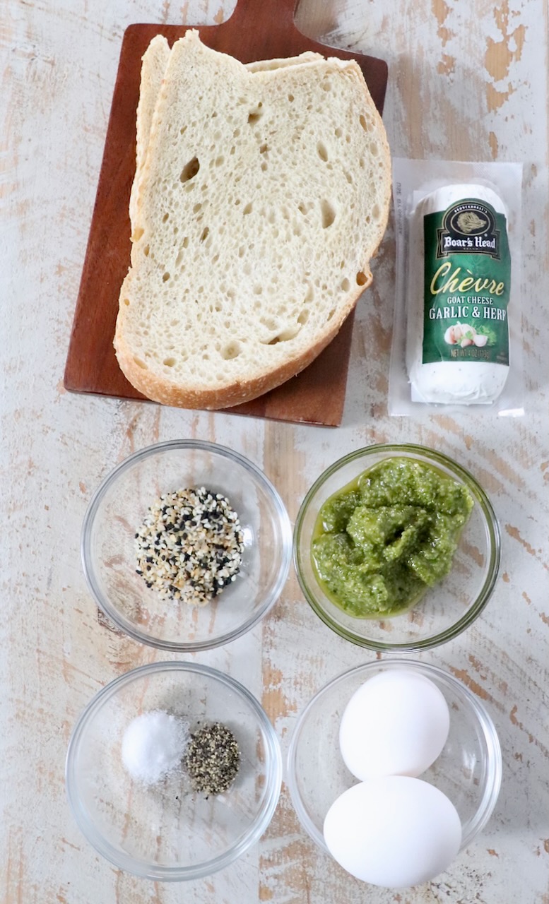 ingredients for pesto eggs on white wood board