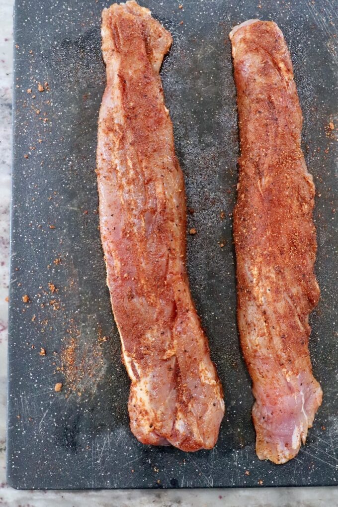 seasoned pork tenderloins on cutting board