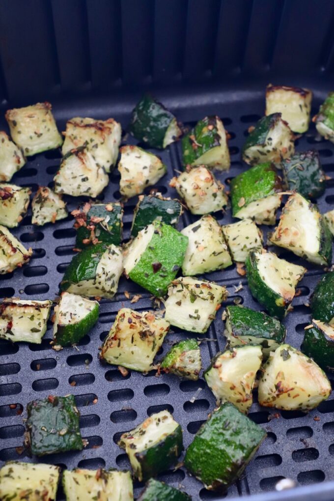 cooked diced zucchini in air fryer basket