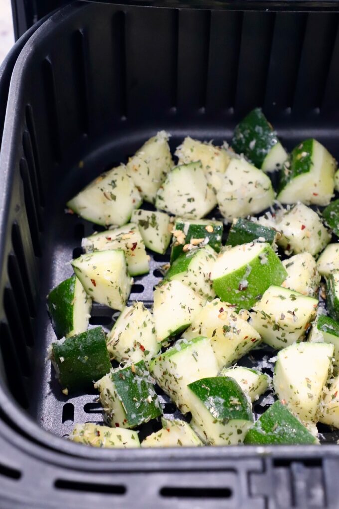 seasoned diced zucchini in air fryer basket