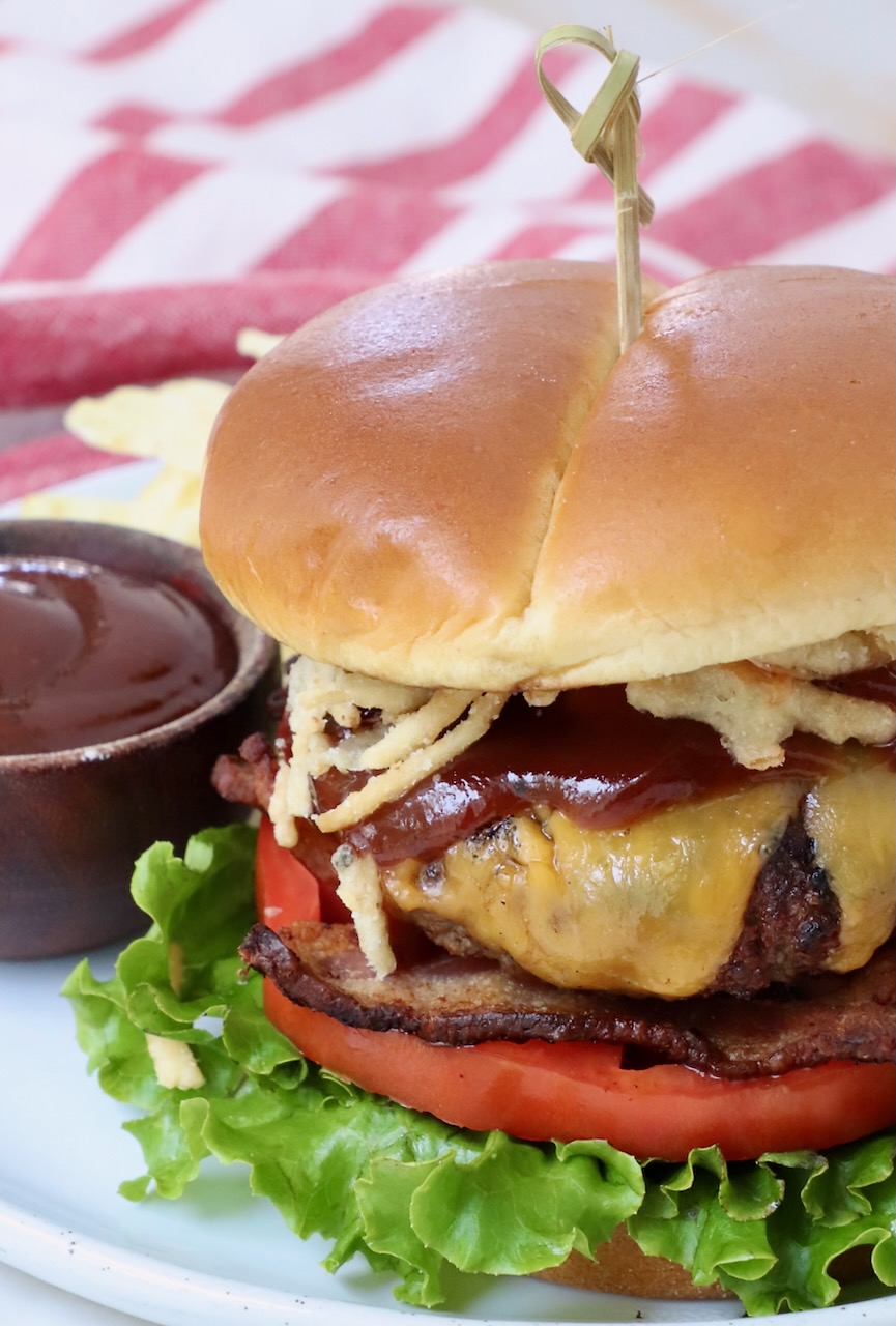 cheeseburger on plate with bbq sauce