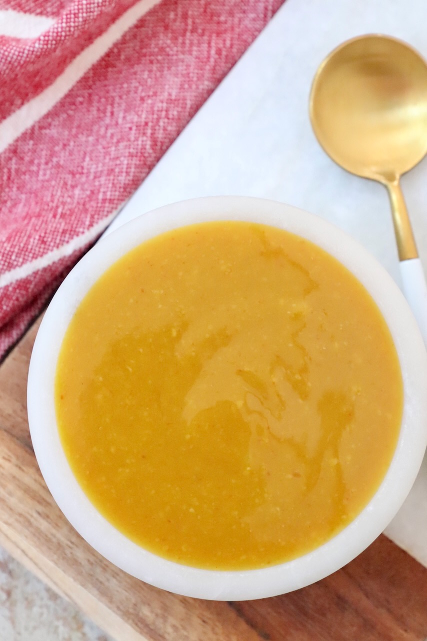 mustard bbq sauce in small bowl with spoon