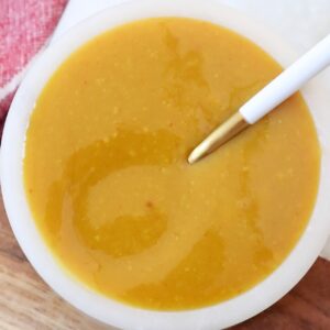 mustard bbq sauce in small bowl with spoon