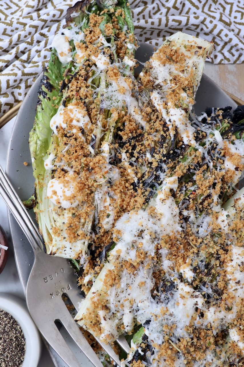grilled caesar salad on plate with serving fork