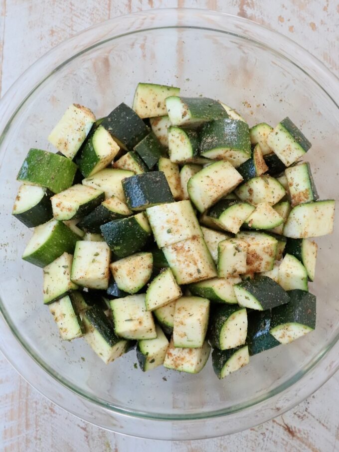 seasoned diced zucchini in glass bowl