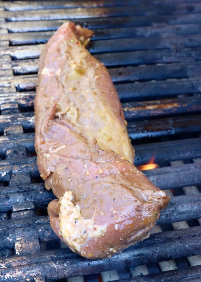 marinated raw pork tenderloin on grill