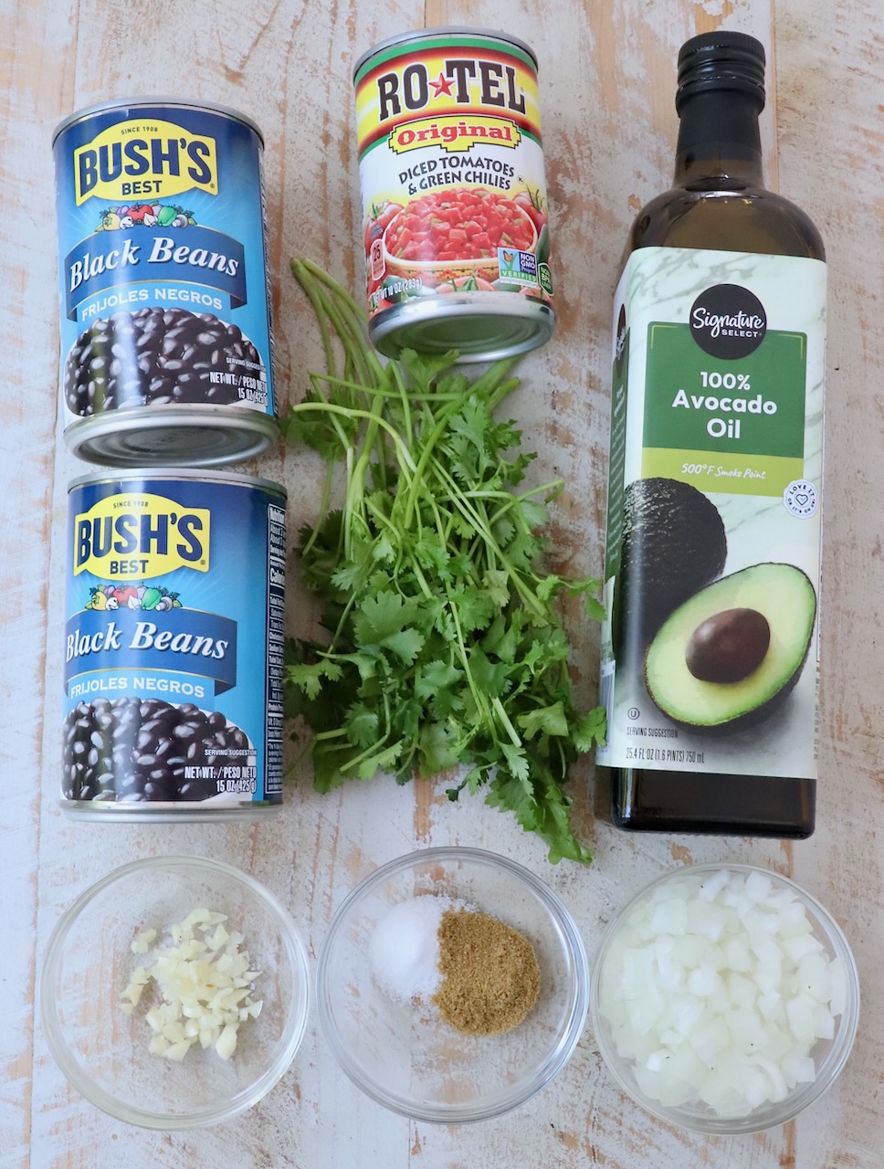 ingredients for Mexican black beans on white wood board